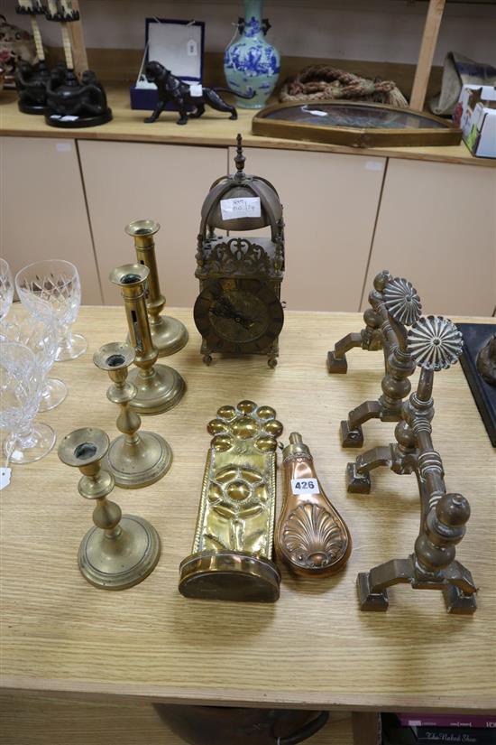 A Dutch brass candle sconce, a pair of Victorian Arts & Crafts brass fire dogs, a lantern clock, etc.
